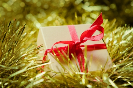 Gift boxes with red ribbon on abstract holiday backgroundの写真素材