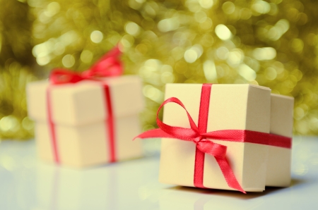 Gift boxes with red ribbon on abstract holiday backgroundの写真素材