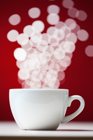 Defocused lights as aroma emanates from white cofee cupの写真素材