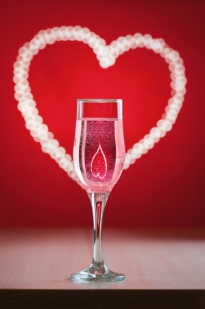 Goblet with wine and with heart symbol reflection insideの写真素材