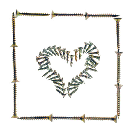 Heart symbol made of screws in frame, isolated on whiteの写真素材