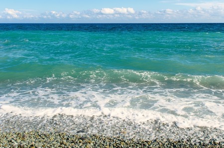 Nice pebble beach and sky with clouds over the horizonの写真素材