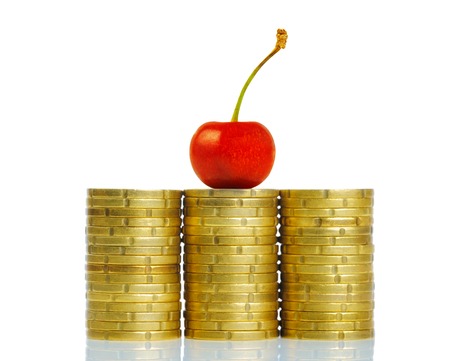 Sweet cherry on coins stackの写真素材