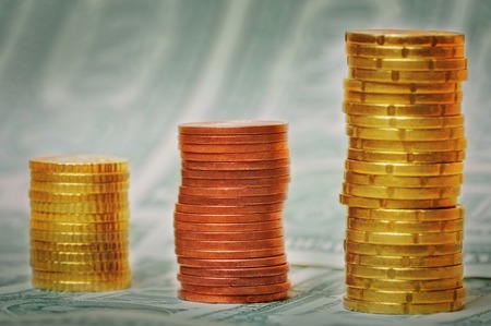 Euro coin columns on USD bank note backgroundの写真素材