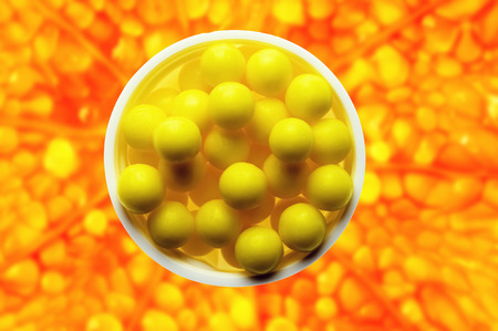 Orange slice with vitamin pills on abstract background