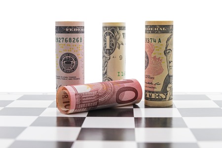 USD and Euro bank notes on chess boardの写真素材