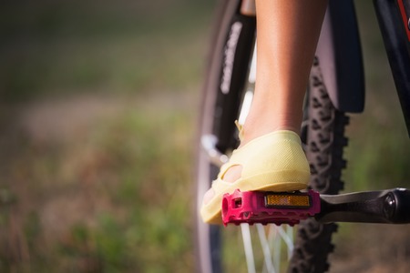 Low viewing angle of woman leg on mountain bike pedalの写真素材