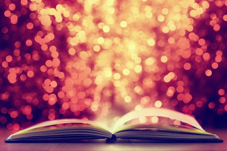 Open book against  defocused  lights abstract backgroundの写真素材