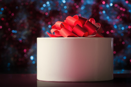 White gift box on abstract defocused lightsの写真素材