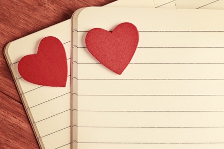 Close up of open notebooks with red heartsの写真素材