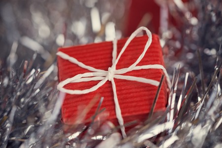 Close up of red gift box in abstract christmas decorationの写真素材