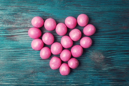 Sweet pink candies on Valentines day over vintage wooden backgroundの写真素材