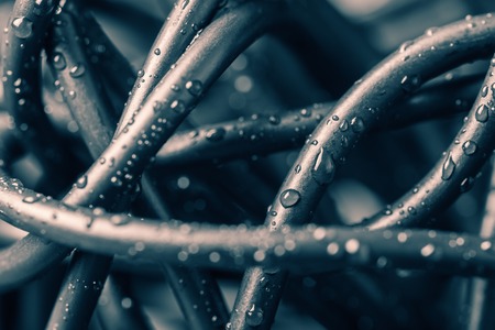 Tangled wires with water drops, abstract backgroundの写真素材