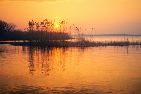 Beautiful Sunset Over  the Lake in Early Springの写真素材