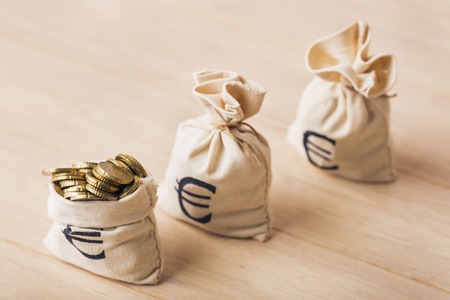 Three money bags with euro coins, selected focusの写真素材