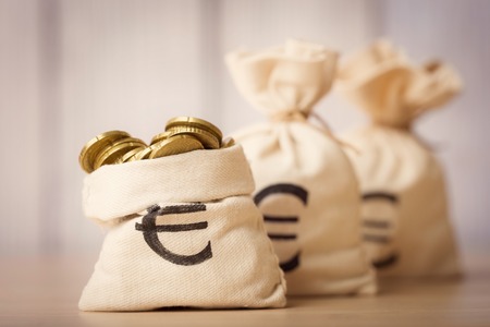 Money bags with euro coinsの写真素材