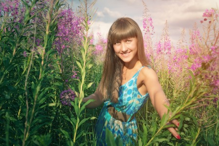 Young woman enjoying a summer  flower fieldの写真素材