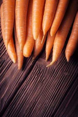 Fresh carrot on old wooden backgroundの写真素材