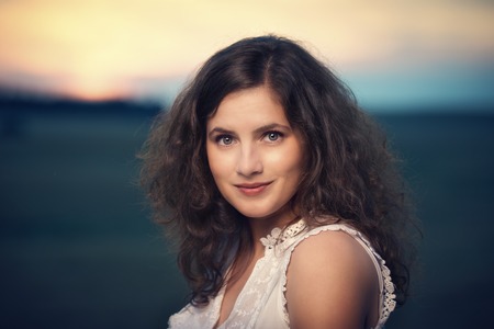 Beautiful brunette young woman with curly hairの写真素材