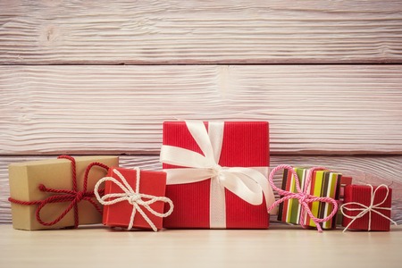 Various gift boxes over vintage wooden background