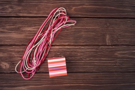 Gift box and decorative cords on old wooden deskの写真素材
