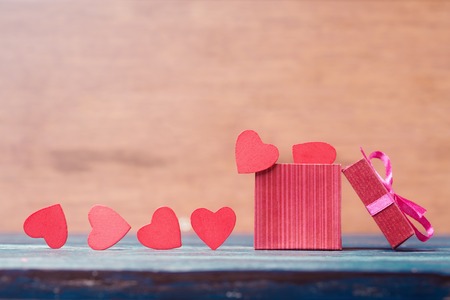 Red hearts and gift box over wooden backgroundの写真素材