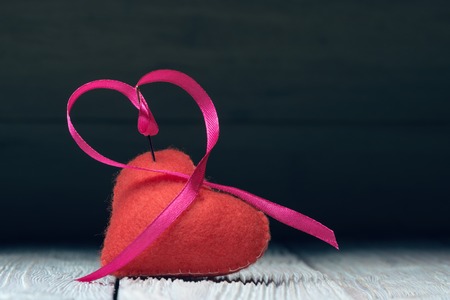 Fabric heart with needle and ribbonの写真素材