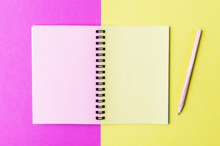 Open notebook and pencil on multicolor backgroundの写真素材