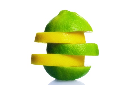 Orange amd lime slices pile isolated on white backgroundの写真素材