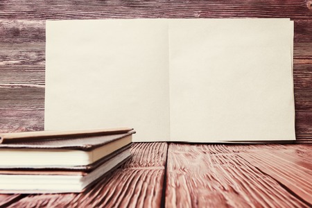 Open note pad on old wooden background