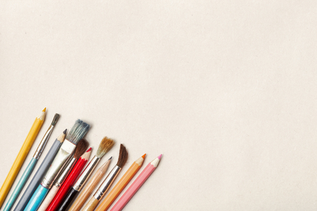 Brushes and pencils over light paper backgroundの写真素材