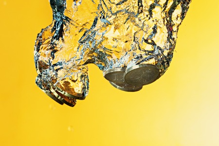 Euro coins in water splashの写真素材