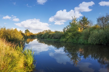 River with clouds reflection in summer timeの写真素材