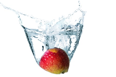 Apple slice in water splash, isolated in whiteの写真素材