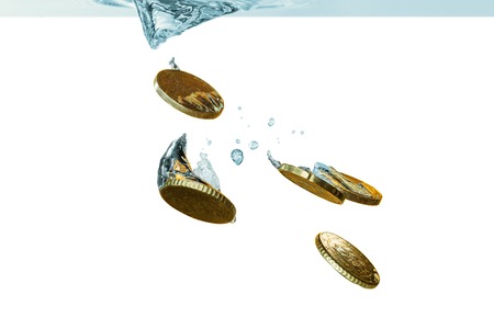 Euro coins falling in water, isolated on whiteの写真素材