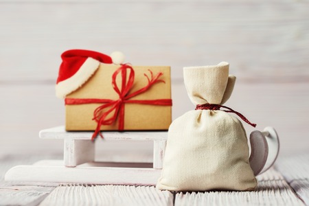 Xmas background with gift box, sledge and canvas sackの写真素材