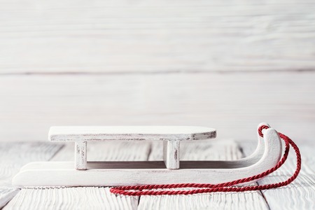 White wooden sledge with red cord, Christmas concept