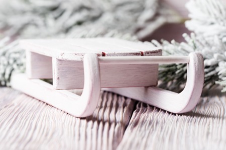 Toy white sledge over Xmas backgroundの写真素材