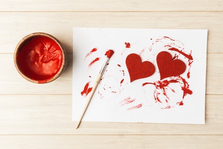 Valentineâs day preparation, hearts painting with red dyeの写真素材