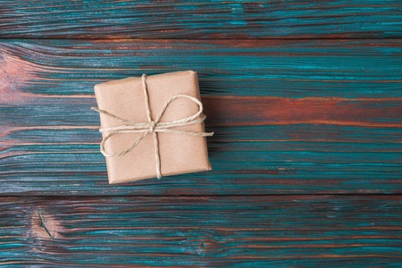 Gift box against old wooden backgroundの写真素材