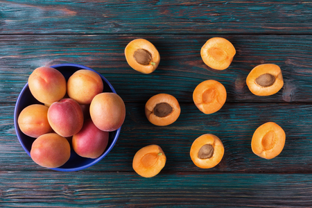 Ripe apricots on old wooden backgroundの写真素材