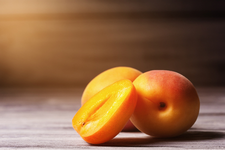 Close up of ripe apricots over  wooden backgroundの写真素材