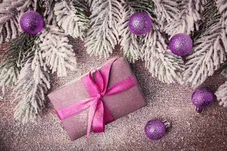 Gift box and Christmas tree branch in snowflakeの写真素材