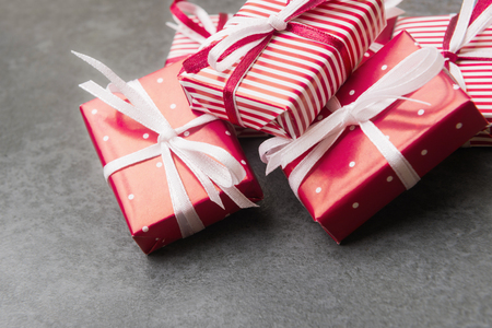 Close up of red gift boxes on stone background.の写真素材