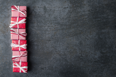 Red gift boxes on dark stone background with copy space.の写真素材