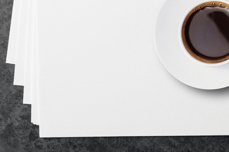 Blank white paper sheets and a cup of coffee.の写真素材