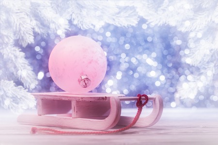 Christmas with glowing bauble on wooden sledge.の写真素材