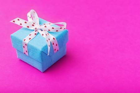 Valentines day decorated blue gift box over pinkの写真素材