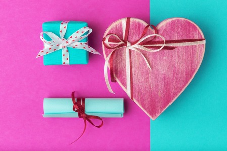 Valentines day concept with gift boxes and love letter over turquoise-pinkの写真素材