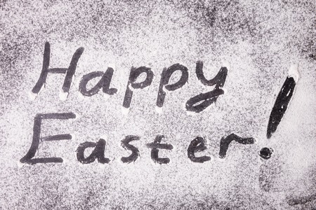 Happy Easter lettering with flour on stoneの写真素材